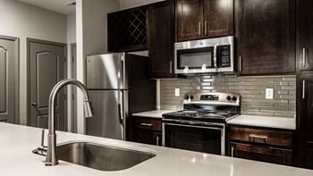 A kitchen with stainless steel appliances and a sink